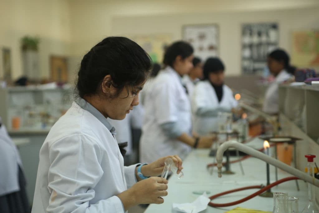 Students in chemistry lab with safety gear